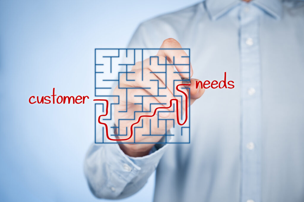 Maze puzzle with a red line tracing the path of a customer’s journey to their needs.