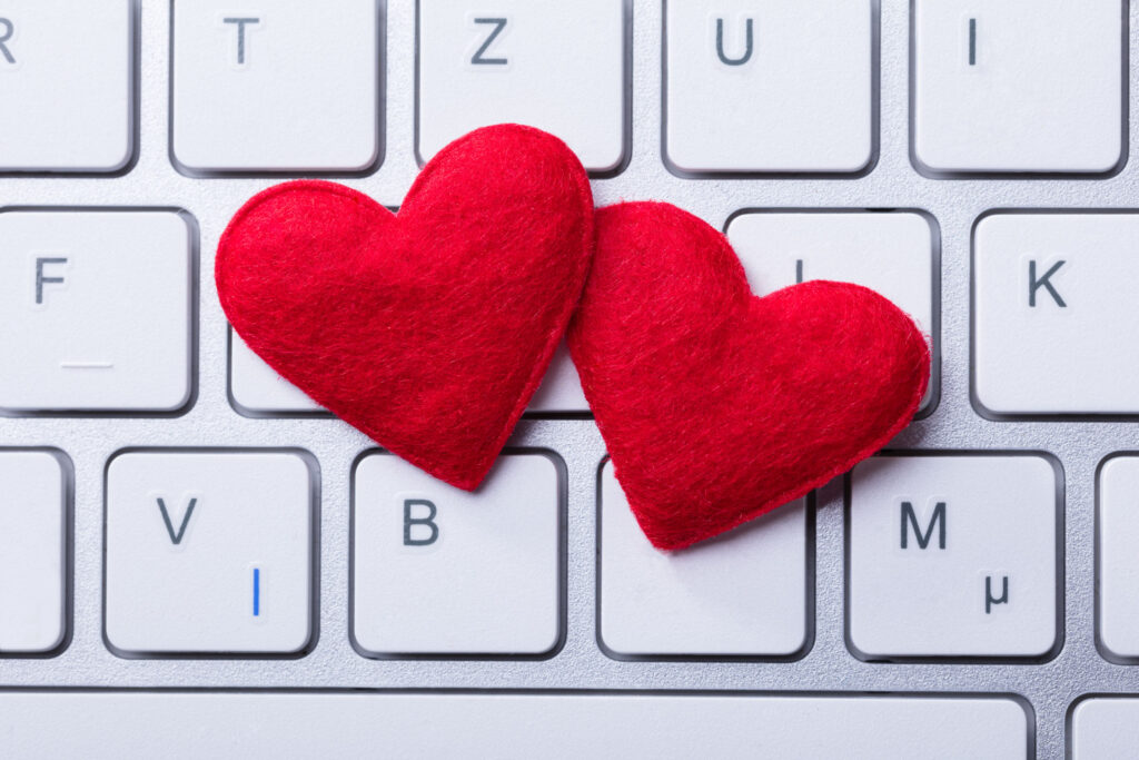 Two hearts are placed on top of a keyboard.