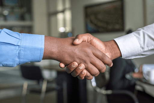 A close-up of two people shaking hands. 