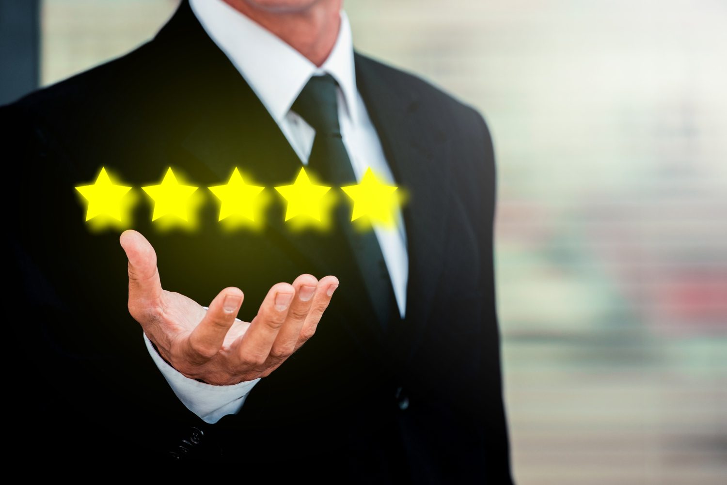 A man holds out his hand with glowing stars floating above it, representing a five-star rating